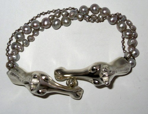 Silver Pearl Bracelet with
                      two horse heads